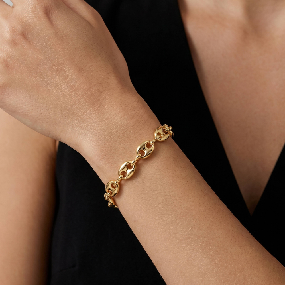 Woman wearing gold Puffy Anchor Bracelet with 8mm links