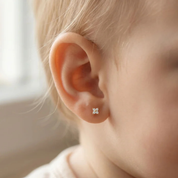 Petite CZ clover flat back earring on ear