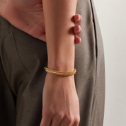 Woman wearing gold Cubic Zirconia Beaded Bangle with pavé stones