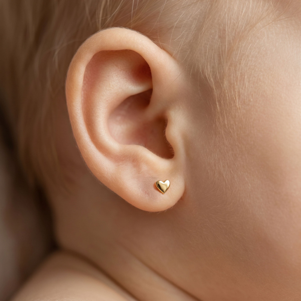 4mm x 5mm heart stud worn on baby 
earlobe