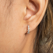 Woman wearing Lab Diamond Huggie Earrings