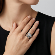 Gold-tone sculptural wrap ring on finger