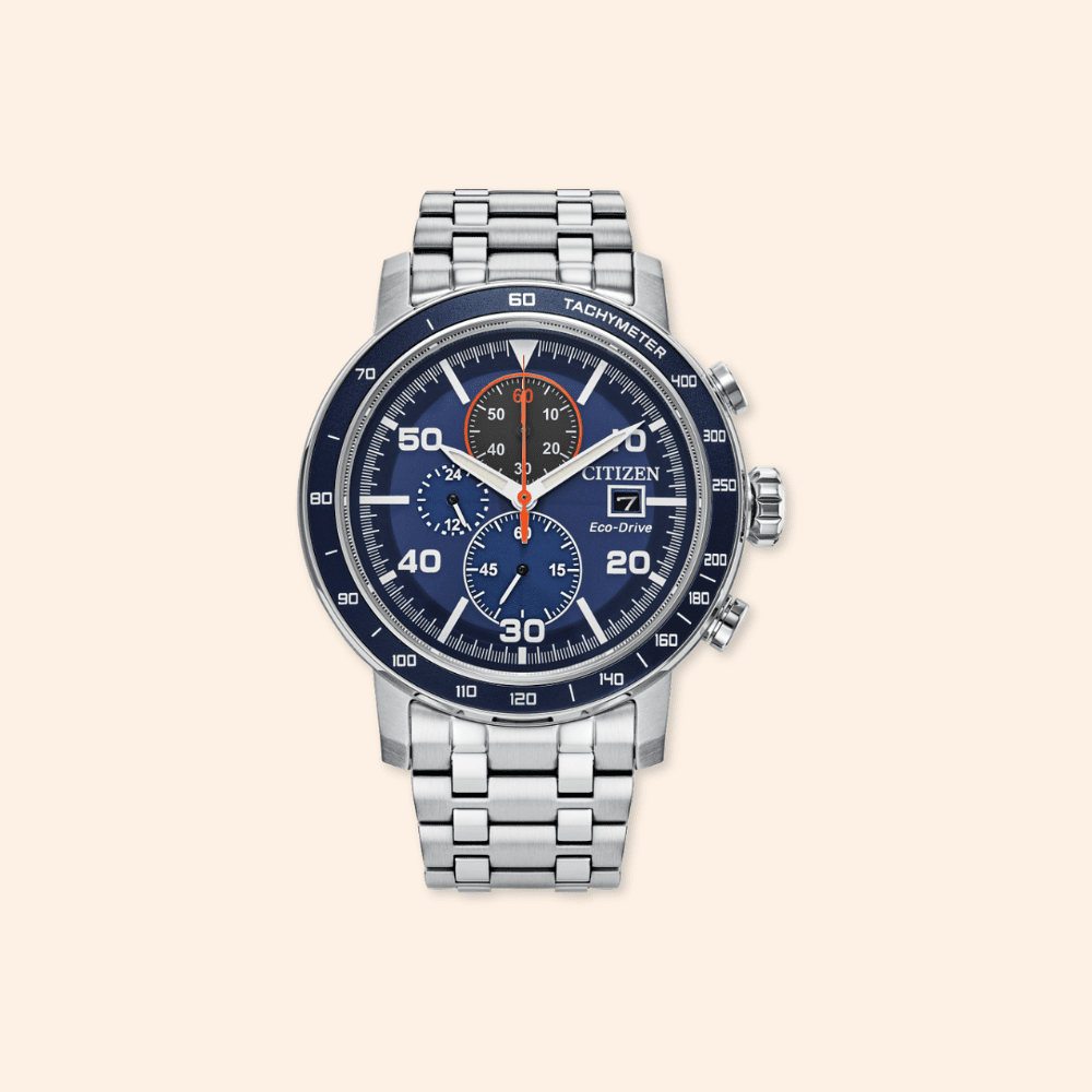 Citizen watch with blue face and silver metal strap on a beige background