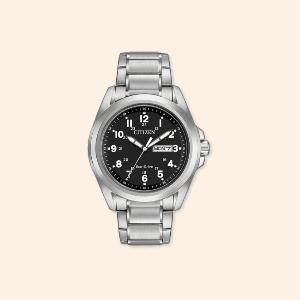 Silver Citizen watch with black dial on a beige background