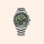 Silver Citizen watch with a green face on a beige background