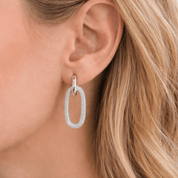 woman wearing oval hoop earrings
