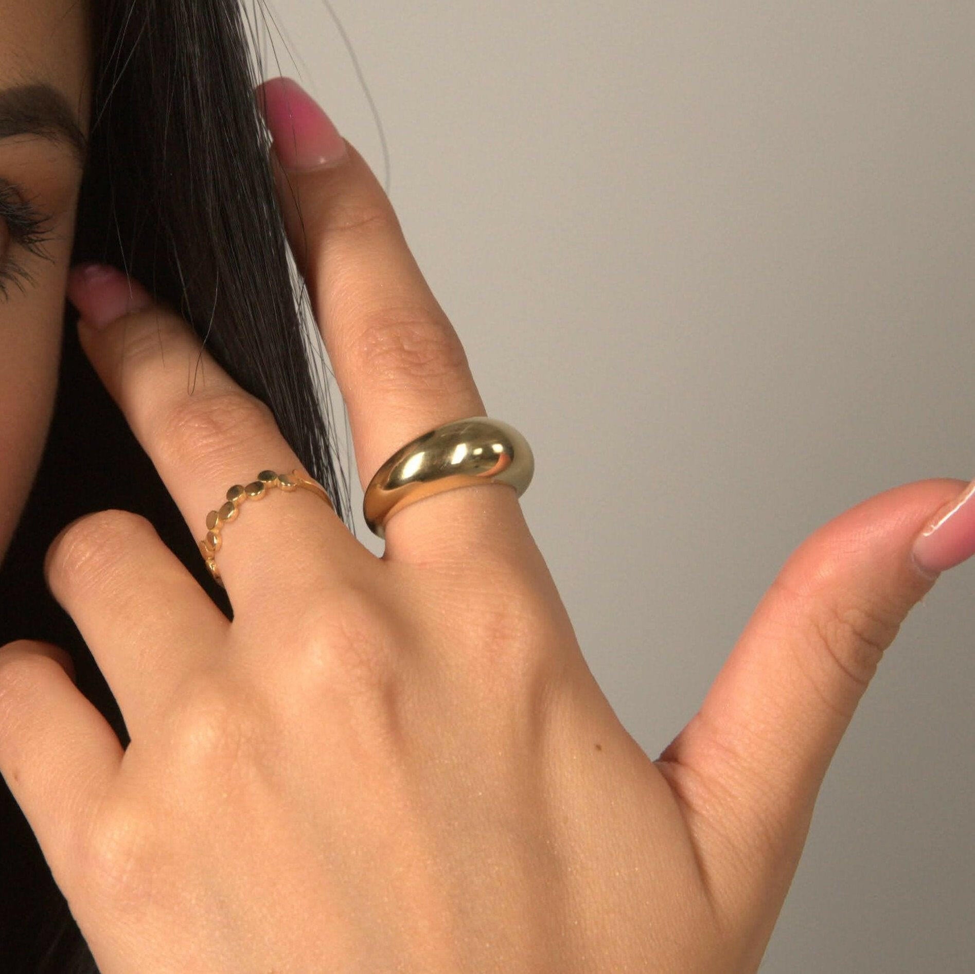 Woman wearing dome ring bold gold statement style