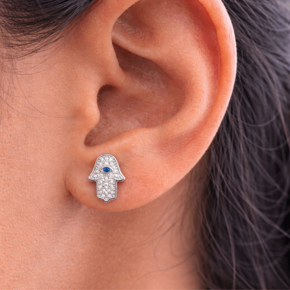 woman wearing Hamsa Eye Studs silver close-up