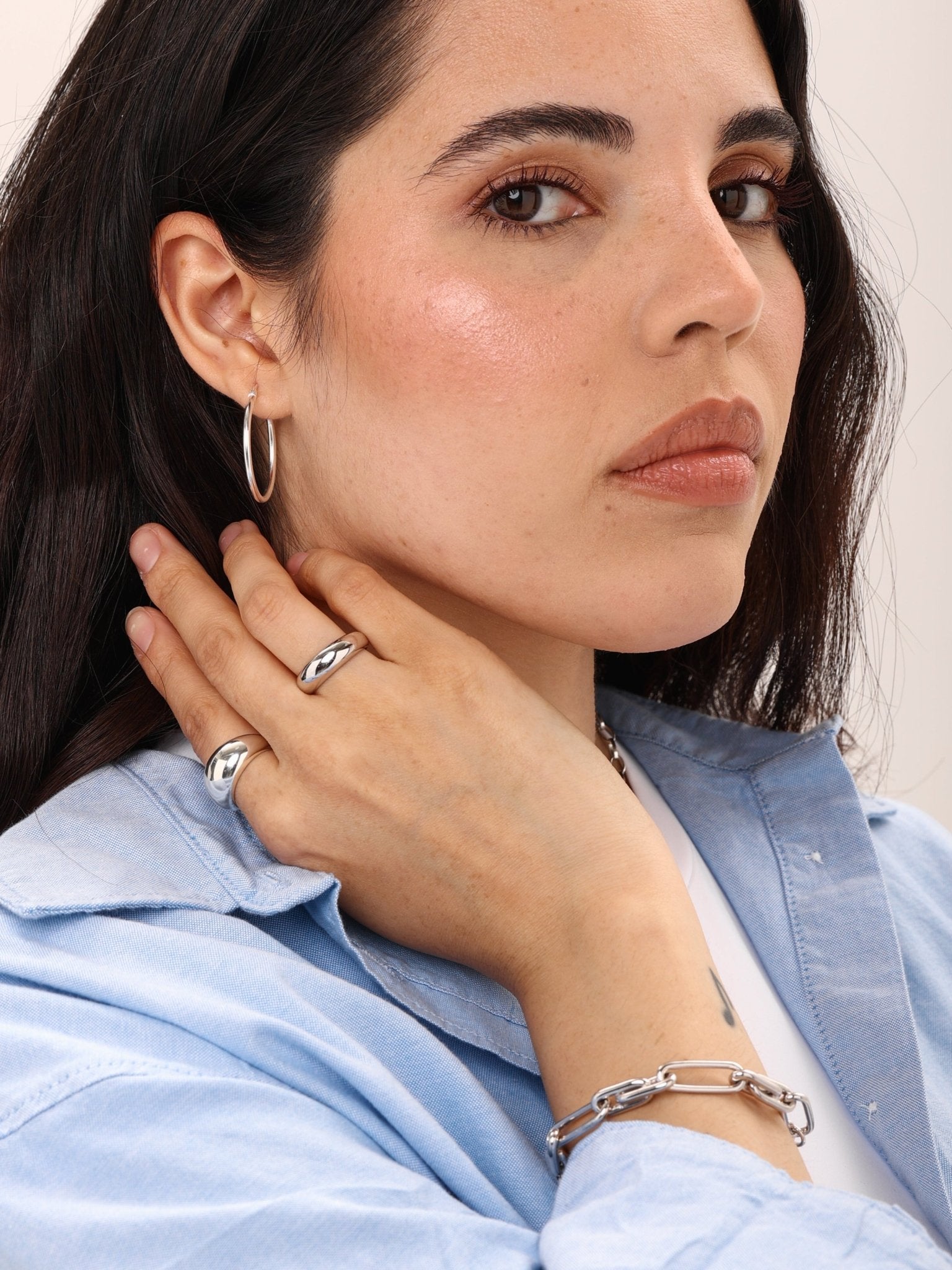 woman styling silver medium dome ring with other jewellery