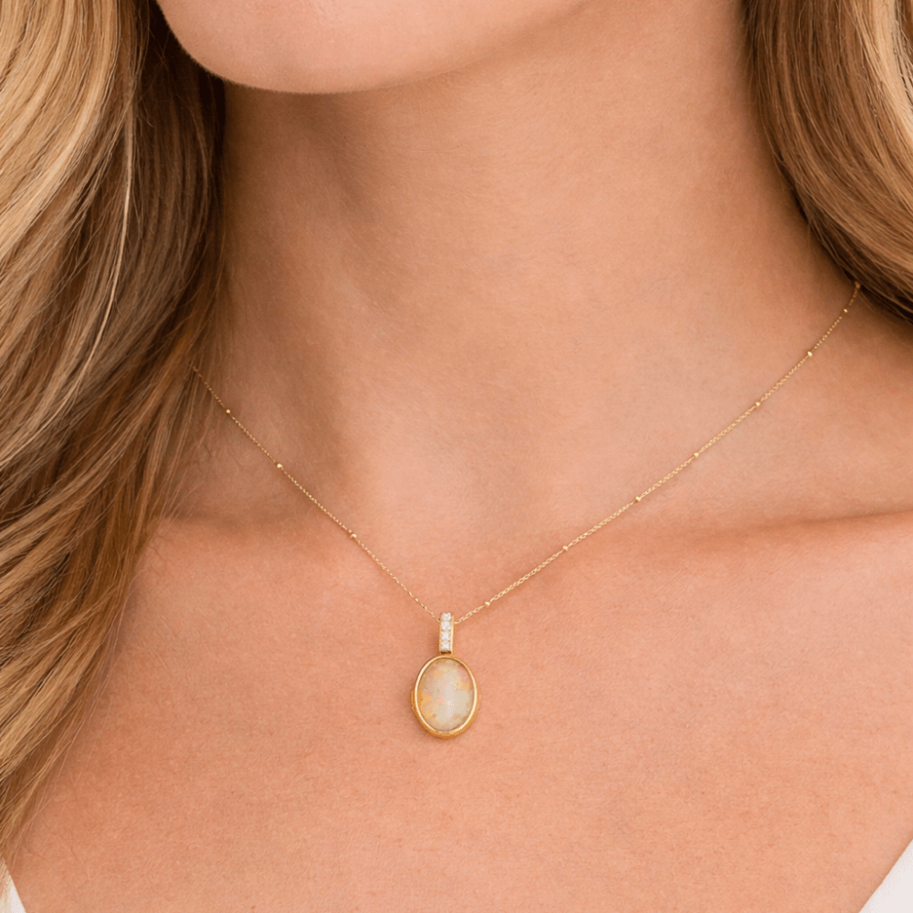 woman wearing opal locket necklace
