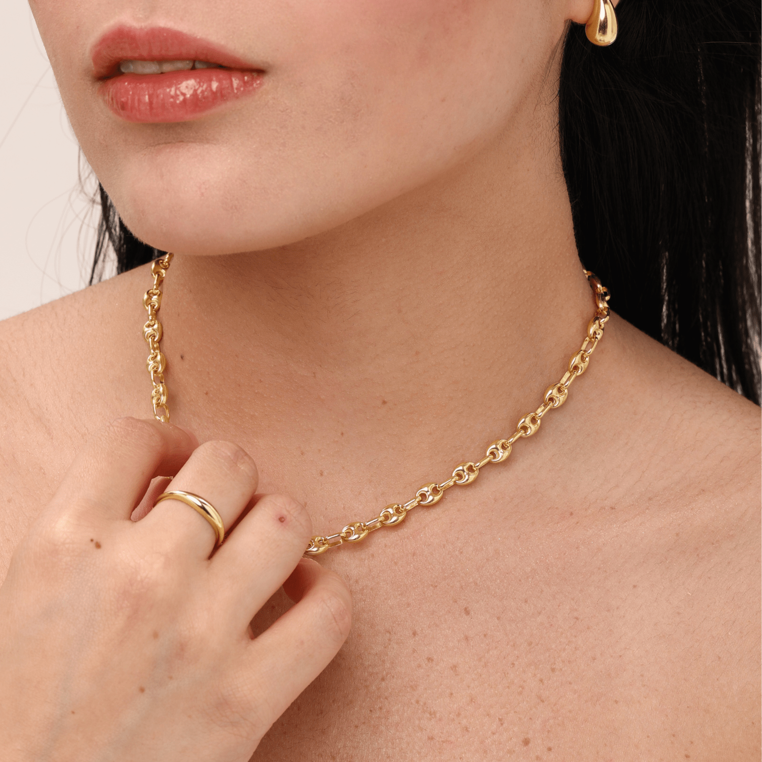 model wearing droplet earrings with layered jewellery