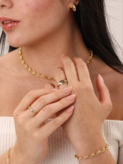 woman styling torsade signet ring with others vermeil jewellery